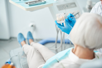 Senior woman is lying in dentist room