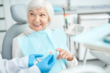 Senior lady asking questions about dental dentures
