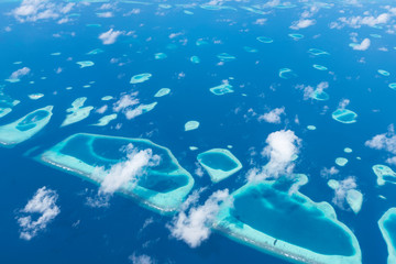 Aerial View from seaplane window over Atolls at Indian Ocean Maldives