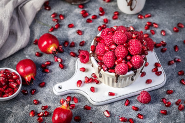Raspberry mug cake in a red ceramic mug on dark background