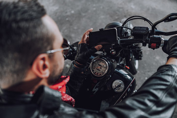 Cropped photo of adult guy is going to ride motorcycle