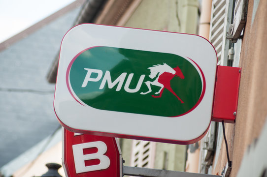  Mulhouse - France - 24 October 2019 - Closeup of PMU logo on store front, the famous french betting sport organisation