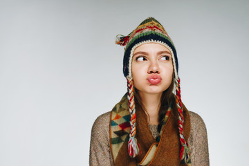 the girl pouted her lips and looks offended. studio gray