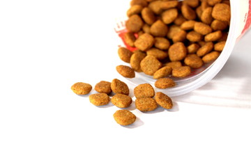 Cat food. Brown dry food. Square pieces.