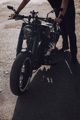 Fototapeta na wymiar Adult biker is about to ride his new motorbike outdoors