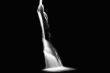 Long exposure of waterfall cascading over rocks, waterfall isolated on black background, Black and White Photo, Fraga da Pena, Portugal