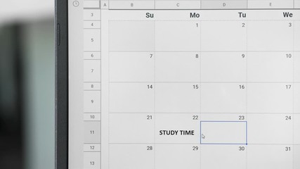 Writing STUDY TIME on monthly weekly planner calendar to remember this date.