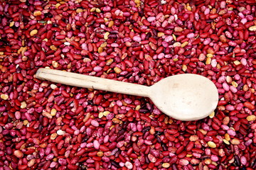 Close up red  mixed beans background with wooden spoon