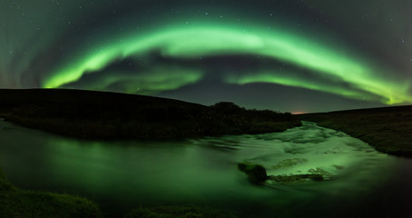 Northern lights with reflection in river, North Iceland