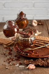 Sun-dried tomatoes with olive oil in a jar of rye bread and a chapel