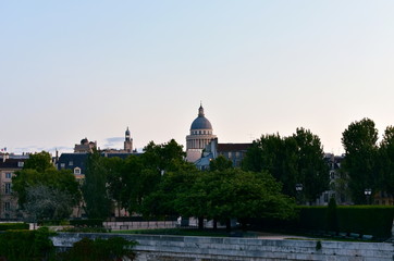The Pantheon Dome and Saint Etienne du Mont Church bell tower at sunset from Ile Saint Louis. Paris, France.
