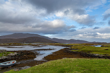 A loch on the Hebridean island of South Uist, with blue sky and clouds overhead