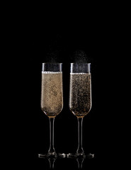full champagne glasses on black background
