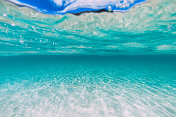 Tropical transparent ocean with sandy bottom underwater