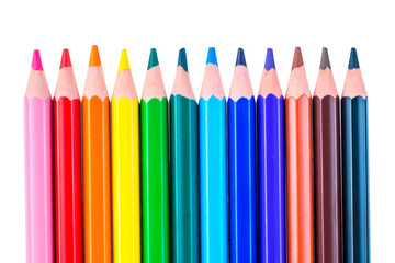 a row of colored pencils sharpened sharply on a white background isolated