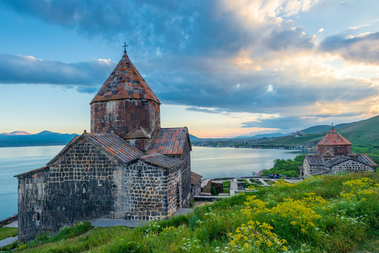 Sevanavank Monastery in the summer at sunset, dramatic sky over Lake Sevan, Armenian heritage