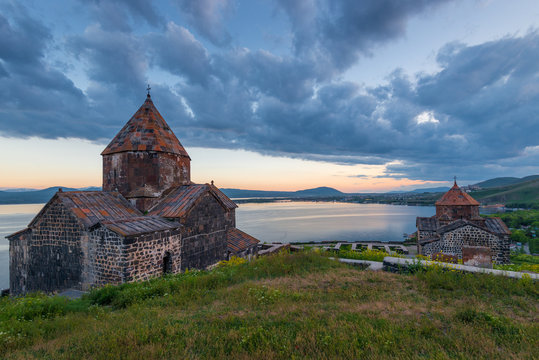Dramatic view of the sights of Armenia - Lake Sevan and the monastery of Sevanavank at sunset