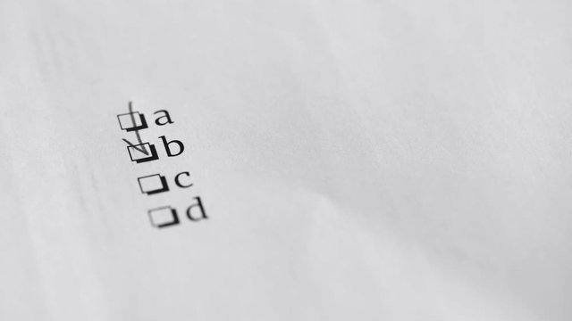 Answer B. Pencil writing answer on paper answer of question in examination test.