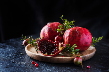 Sweet red pomegranate with green leaves