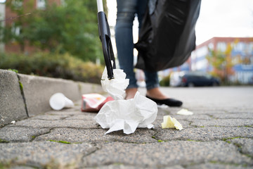 Woman Collecting Trash Outdoors