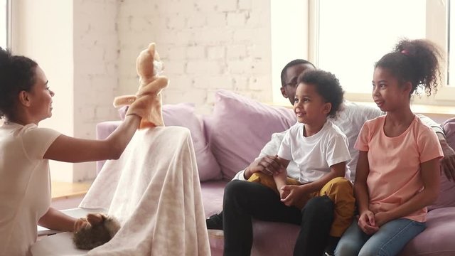 African mother showing for children performance with soft toys