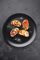Brusquettes, Assorted, Fish, Prawns, Meat, Vegetables, Seafood, on a black background
