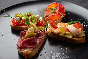 Brusquettes, Assorted, Fish, Prawns, Meat, Vegetables, Seafood, on a black background