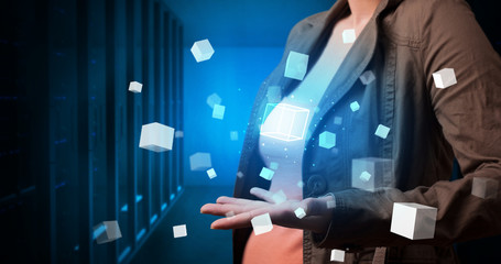 Person holding hologram projection displaying white cubes in server room
