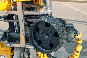 Cog furface of harvester head closeup as a part of gripping unit mechanism for forest harvester crane. Prong roller of harvester head.Heavy duty vechikles and equipment.