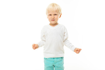 Little boy with short blonde hair, blue eyes, cute appearance, in white jacket, light blue pants, standing and smiling