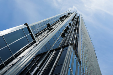 Picture of a very tall glass skyscraper from the bottom up