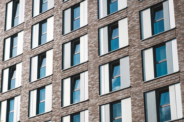 Obraz premium windows on hotel building facade or office building exterior -