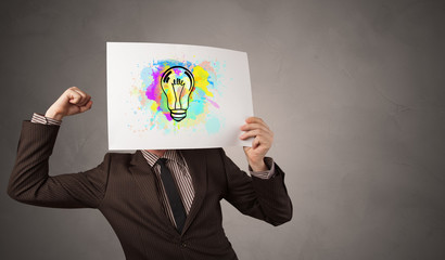 Fototapeta premium Person holding a paper with a drawn colorful idea concept