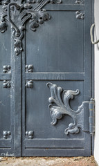 Close-up of ancient vintage metal door with cast iron floral deorative ornament