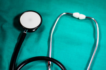 stethoscope on green cloth background