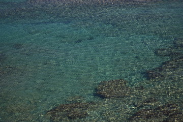 Rocks, sand, turquoise water and ripples, Crete, Mediterranean sea