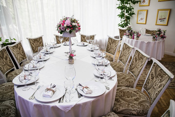 catering at a top event, glasses and flowers on the table, preparation for a significant event, beautiful dishes and glasses on the table, New Year's holiday table
