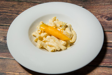 Penne pasta with cheese served in the restaurant