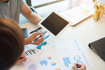 Young business people brainstorm ideas to analyze marketing strategies and plans.