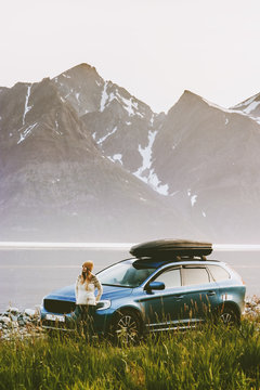 Travel by rental car woman on road trip in Norway adventure lifestyle concept vacations outdoor mountains and fjord view