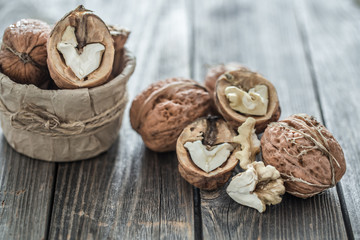 Walnut in open form on a wooden background, close-up .