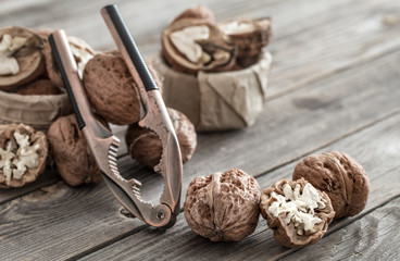 Organic Walnut lies on a wooden background , close-up .