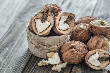Walnut in open form on a wooden background, close-up .