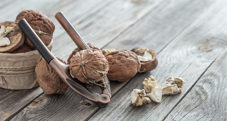 Organic Walnut lies on a wooden background , close-up .
