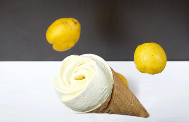Waffle cone filled with marshmallows. Marshmallows in the form of a flower. Soars in the air. Near the fruits of quince.