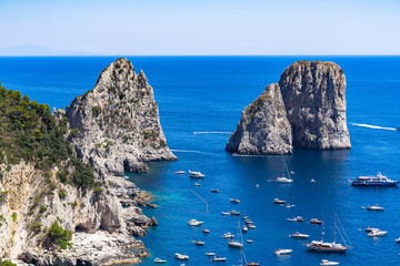 Obraz premium The Faraglioni are three scenic rocks emerging from the sea near Capri coastline, Italy