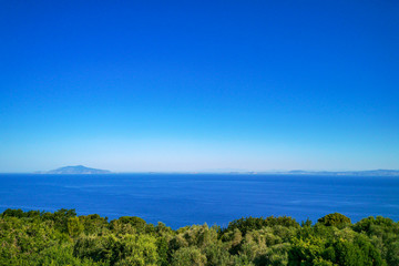 Fototapeta premium Seascape in a clear sunny day from Anacapri with a view on Gulf on Naples and Ischia island on the right, Campania, Italy