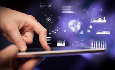 Hand holding tablet with global business concept