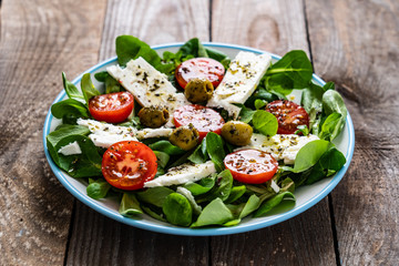 Greek salad on wooden background