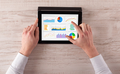 Hand making diagrams and charts on tablet